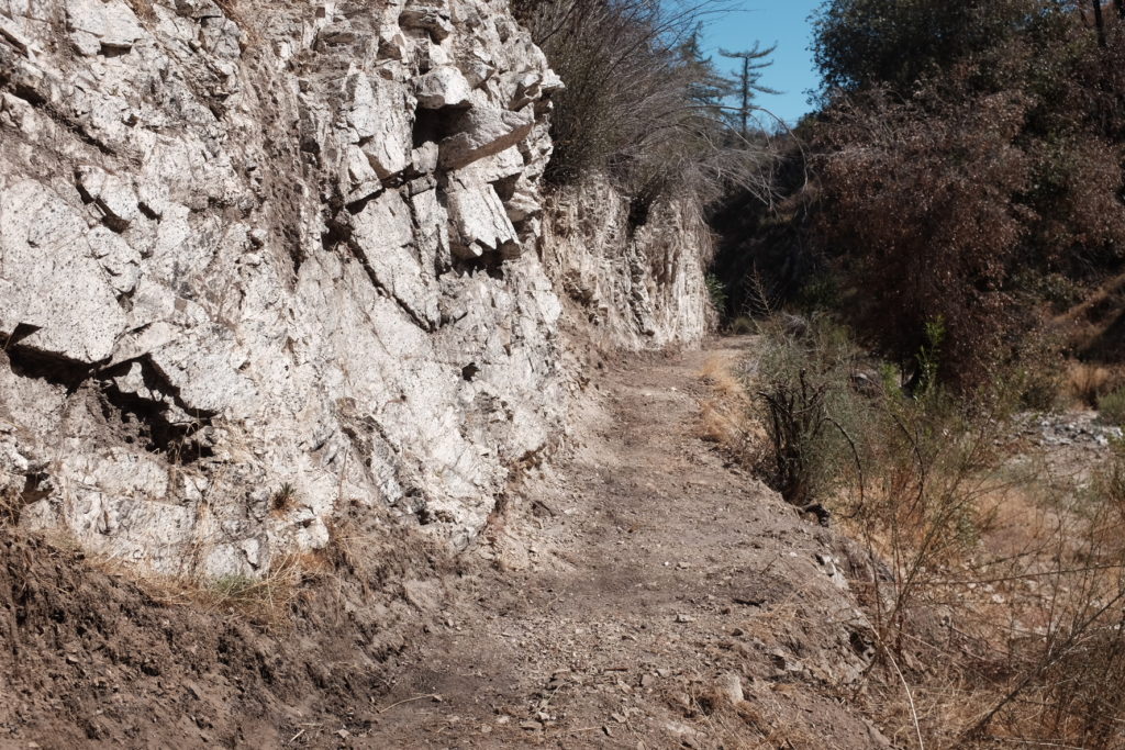 A newly restored segment of trail along a rocky cliffside in Shortcut Canyon.