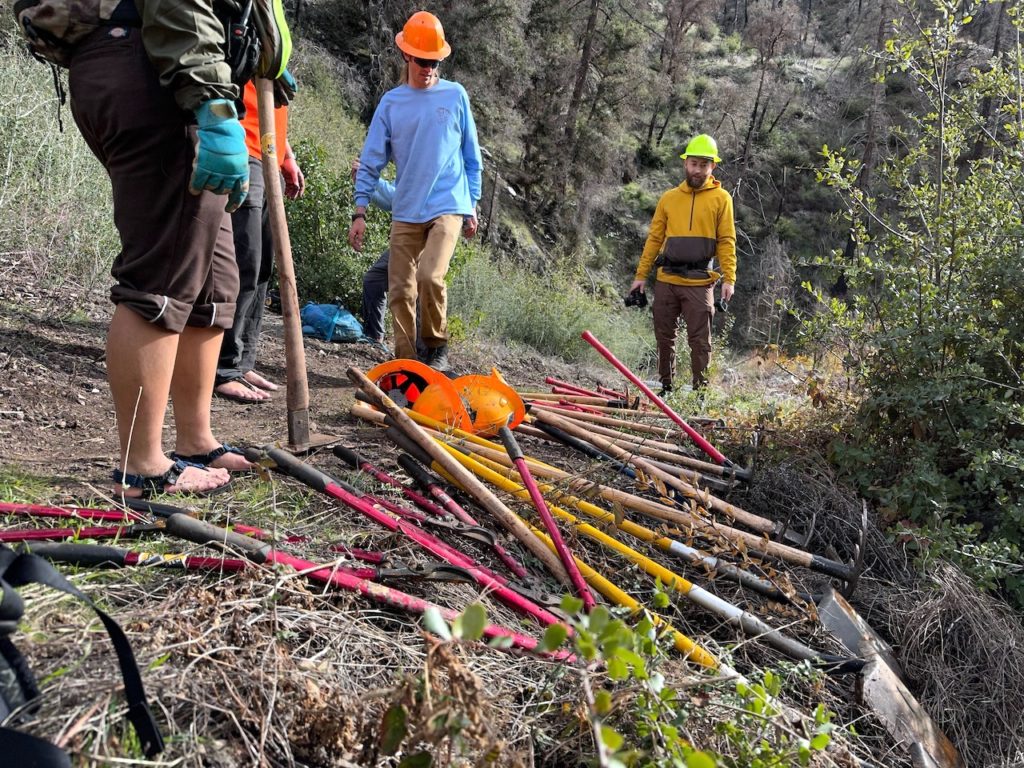 Volunteers and pile of tools.