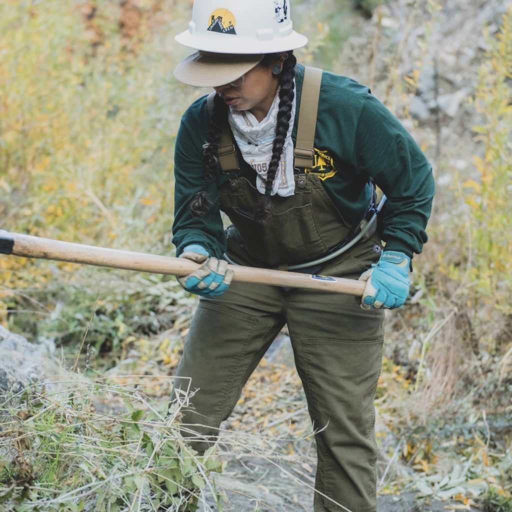trail worker with hand tool